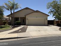 Charming single-story home featuring a well-manicured front yard with mature palm trees and an attached two-car garage at 4523 E Gleneagle Dr, Chandler, AZ 85249