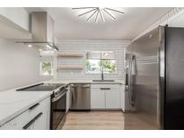 Modern kitchen features stainless steel appliances, white cabinets, quartz countertops and ample natural light at 527 N Pasadena --, Mesa, AZ 85201