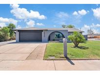 Charming single-story home with a gray brick exterior, well-manicured lawn, and covered entryway at 6420 S Wilson St, Tempe, AZ 85283