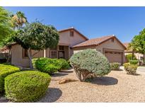 Charming single-story home featuring a well-maintained landscape, mature trees, and a two-car garage at 6758 W Quail Ave, Glendale, AZ 85308