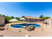 Inviting backyard pool and patio area perfect for relaxing and entertaining outdoors at 723 N Joshua Tree Ln, Gilbert, AZ 85234