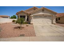 Charming single-story home with a well-maintained yard and attached two-car garage at 7603 W Oraibi Dr, Glendale, AZ 85308