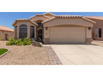Charming single-story home featuring a well-maintained front yard and a two-car garage at 9559 W Runion Dr, Peoria, AZ 85382
