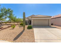 Charming single-story home featuring a desert landscape, tile roof, and a two-car garage in a sunny location at 17108 N Estrella Vista Dr, Surprise, AZ 85374