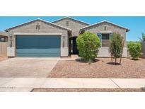 Charming single-Gathering home featuring a well-maintained yard, a two-car garage, and desert landscaping at 17652 W Fetlock Trl, Surprise, AZ 85387