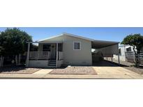 Inviting home featuring covered parking and a charming front porch area at 18026 N Cave Creek Rd # 140, Phoenix, AZ 85032