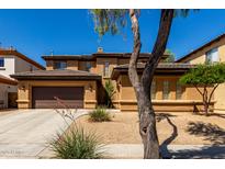 Charming two-story home boasts a spacious front yard, a two-car garage, and a cozy front porch at 2030 W Whisper Rock Trl, Phoenix, AZ 85085
