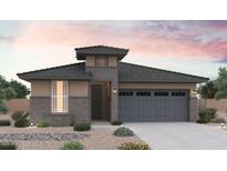 Charming single-story home with a stone facade, gray roof, and desert landscaping for a modern look at 31982 N 117Th Ave, Peoria, AZ 85383
