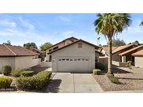 Charming single-Gathering home with a two-car garage, mature landscaping, and a beautiful palm tree in the front yard at 4182 W Park Ave, Chandler, AZ 85226