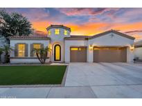 Stunning single-story home with a well-manicured lawn, desert landscaping, and a three-car garage at 4206 E Blue Ridge Pl, Chandler, AZ 85249