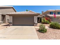 Charming home featuring a well-kept yard with a spacious driveway and an attached two-car garage at 5018 W Wikieup Ln, Glendale, AZ 85308