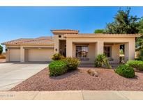 Charming single-story home with a well-maintained landscape and a spacious three-car garage at 5102 S Peachwood Dr, Gilbert, AZ 85298