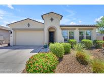 Beautiful front exterior showcases a charming home with a well-manicured, landscaped yard at 5637 S Parrish --, Mesa, AZ 85212