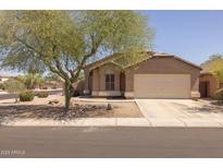 Charming single-story home featuring a landscaped front yard and a two-car garage at 718 E Devon Dr, Gilbert, AZ 85296