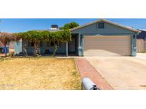 Charming single-story home with a well-maintained lawn and a cozy, covered porch entrance at 8042 W Mariposa Dr, Phoenix, AZ 85033