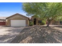 Charming single-story home featuring a two-car garage, desert landscaping, and a mature shade tree at 10727 E El Moro Ave, Mesa, AZ 85208