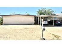 Single story home with a brick facade, carport, desert landscaping and a mailbox at 1231 E Avila Ave, Casa Grande, AZ 85122