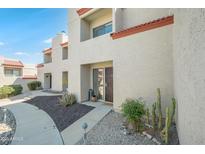 Charming condo features desert landscaping, walkway, and a red tile roof, creating a welcoming curb appeal at 1401 E Puget Ave # 24, Phoenix, AZ 85020