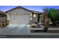 Charming single-story home showcasing a well-maintained front yard, a two-car garage, and desert landscaping at 14360 W Pershing St, Surprise, AZ 85379