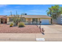 Charming home showcasing desert landscaping and a well-maintained front yard with an attached one-car garage at 14808 N 37Th Way, Phoenix, AZ 85032