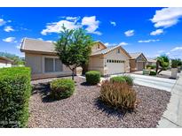 Charming single-story home featuring low-maintenance desert landscaping and a two-car garage at 15194 W Vale Dr, Goodyear, AZ 85395