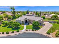 Expansive front yard featuring mature trees, lush landscaping, and a well-maintained lawn leading to the beautiful home at 1940 N Stevens Cir, Mesa, AZ 85205