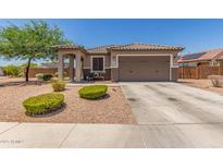 Charming single-story home with a well-maintained front yard and a two-car garage at 20109 W Madison St, Buckeye, AZ 85326