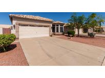 Charming single-story home features a two-car garage, desert landscaping, and a beige exterior at 20632 N 103Rd Ave, Peoria, AZ 85382