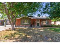 Charming brick home featuring mature trees and a well-maintained lawn at 3538 W Sierra Vista Dr, Phoenix, AZ 85019