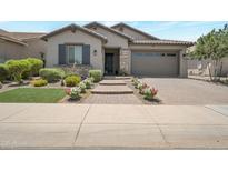 Charming home featuring a stone facade, paved driveway, and well-maintained landscaping at 41215 W Almira Dr, Maricopa, AZ 85138