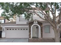 Charming two-story home featuring a stone-accented entrance and a well-maintained front yard at 4145 E Santa Fe Ln, Gilbert, AZ 85297