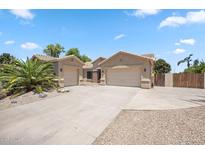 Charming home with a three car garage, desert landscaping, and a spacious driveway at 422 E Kaibab Pl, Chandler, AZ 85249