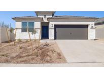 Charming single-Gathering home featuring a two-car garage, desert landscaping, and a modern blue front door at 5566 S 254Th Gln, Buckeye, AZ 85326