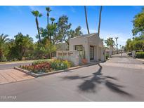 A beautiful desert landscape and palm trees surround the entrance to Scottsdale House Condominiums at 6138 N 28Th St, Phoenix, AZ 85016