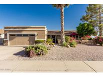 Charming single story home featuring a well-maintained yard with desert landscaping and an attached two-car garage at 1087 Leisure World --, Mesa, AZ 85206