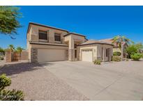 Stunning two-story home featuring a three-car garage and stone accents at 1120 E Jahns Dr, Casa Grande, AZ 85122