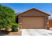 Charming home featuring a two-car garage, low maintenance landscaping, and a cozy, inviting facade at 1662 E Kingman Pl, Casa Grande, AZ 85122