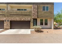 Modern townhome showcasing stone accents, private balcony, and a single-car garage at 2000 N 36Th St # 14, Phoenix, AZ 85008