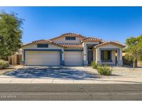 Charming single-story home featuring a three-car garage, tile roof, and well-maintained landscaping at 29688 W Indianola Ave, Buckeye, AZ 85396