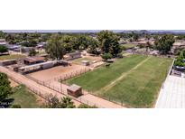 Expansive horse property with a paddock, riding arena and lush green pastures for equestrian enthusiasts at 4145 W Banff Ln, Phoenix, AZ 85053