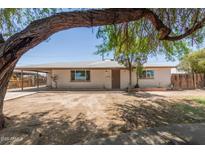 Charming single-story home with brick accents and a well-maintained front yard at 716 S Lewis --, Mesa, AZ 85210