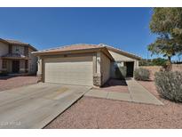 Charming single-story home featuring a two-car garage and neutral-colored exterior, enhanced by a well-maintained yard at 12117 N 127Th Dr, El Mirage, AZ 85335