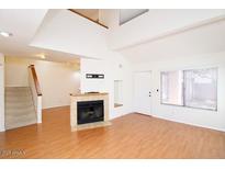 Bright living room with a fireplace and large window for natural light at 16644 N 33Rd St # 101, Phoenix, AZ 85032