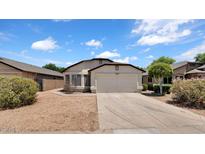 Charming single-story home with a two-car garage and low maintenance desert landscaping at 17115 N Larkspur Ln, Surprise, AZ 85374