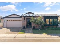 Charming brick home featuring a manicured lawn and a two-car garage, offering classic curb appeal at 3890 E Andalusia Ave, Gilbert, AZ 85298