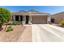 Charming single-story home featuring a well-manicured front yard and inviting covered porch at 4067 W Maggie Dr, San Tan Valley, AZ 85144
