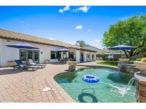 Inviting backyard pool with waterfall feature and lounge seating, perfect for relaxation and outdoor entertaining at 4507 E Duane Ln, Cave Creek, AZ 85331
