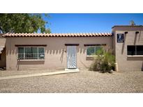 Charming condo featuring a traditional southwestern style with a tile roof and secure front door at 4625 W Thomas Rd # 48, Phoenix, AZ 85031