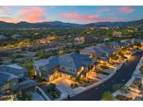 Stunning two-story home featuring landscaped front yard and mountain views during sunset at 5100 E Rancho Paloma Dr # 1044, Cave Creek, AZ 85331