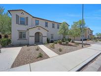 Inviting two-story home with a neutral palette, desert landscaping, and a welcoming entrance at 5805 W Warner St, Phoenix, AZ 85043